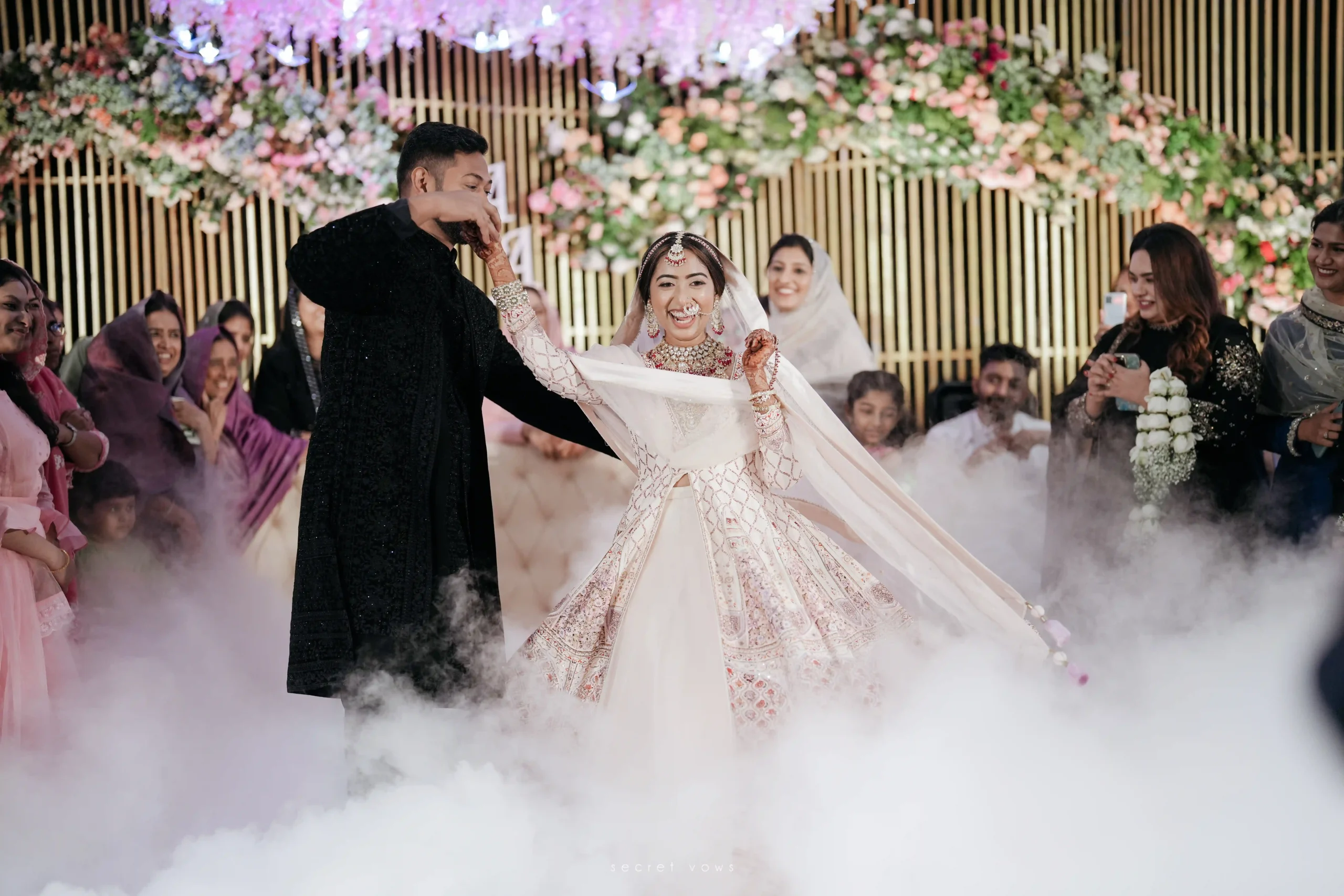 Romantic first dance of bride and groom on decorated stage
