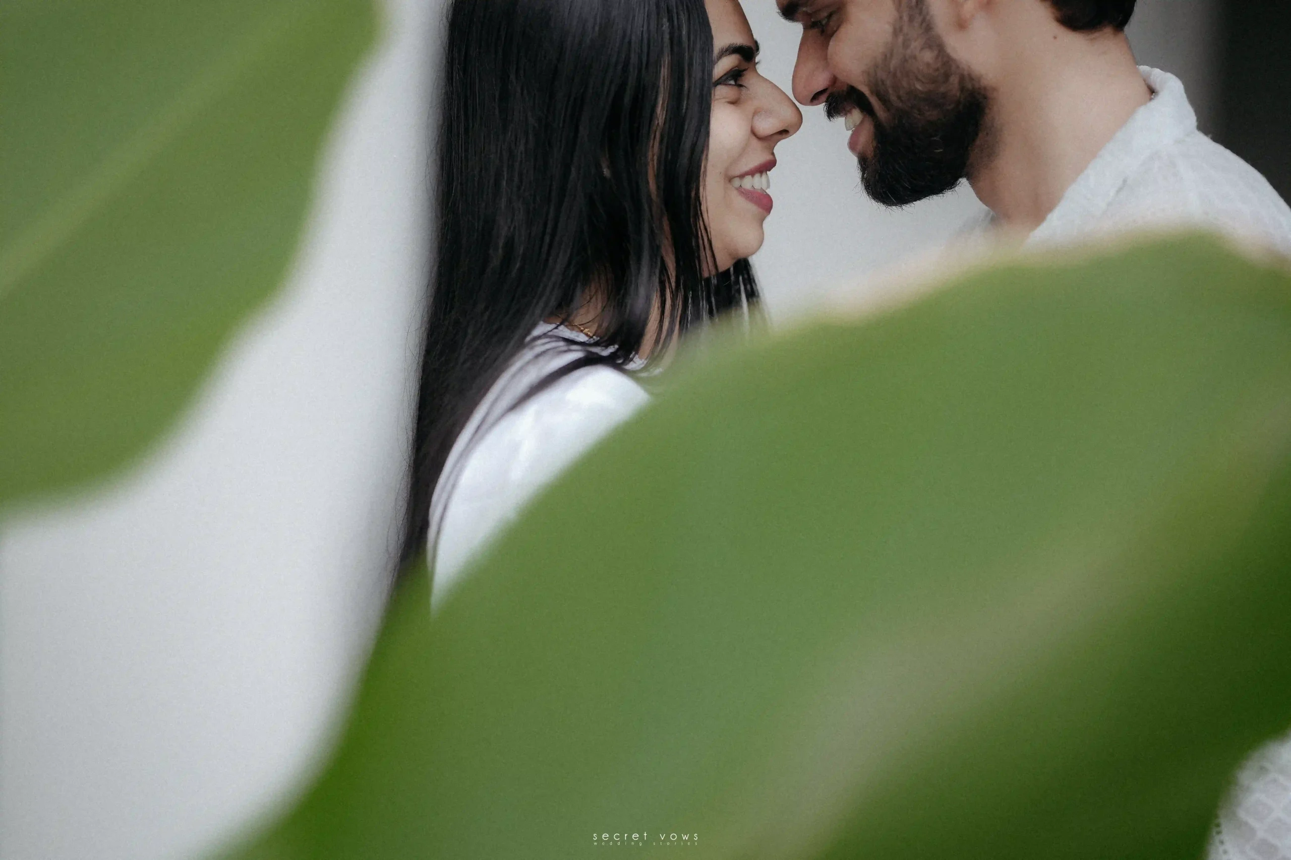 Romantic pre-wedding moment with bride and groom touching foreheads