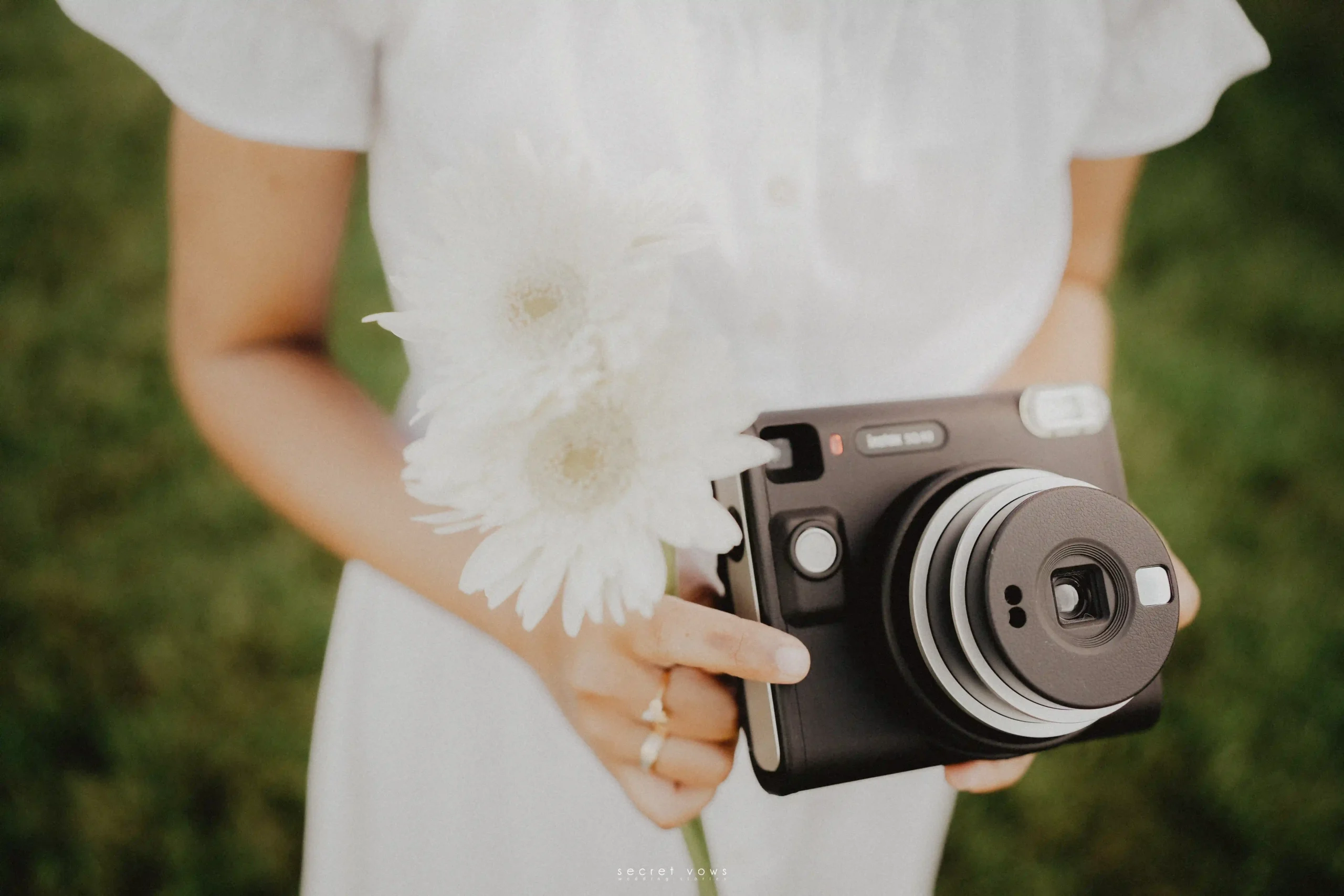 Bride’s hand holding a vintage camera – creative wedding photoshoot