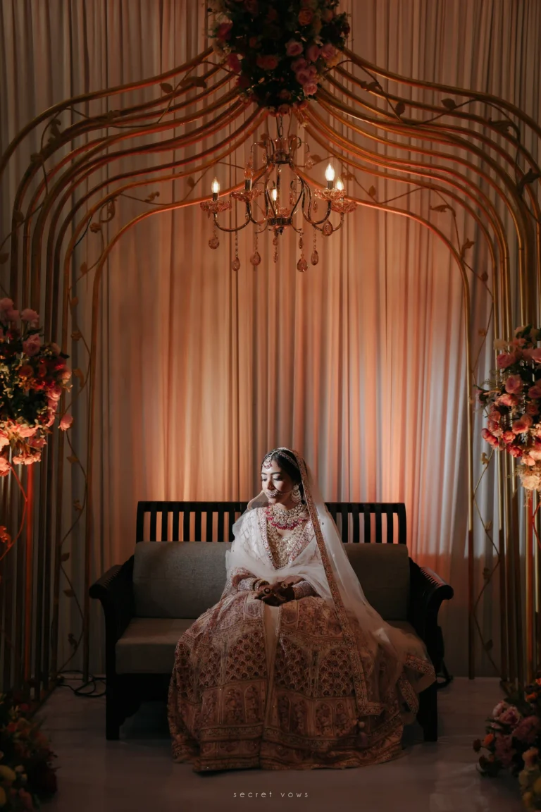 Bride seated in a heritage Kerala location wearing classic wedding dress