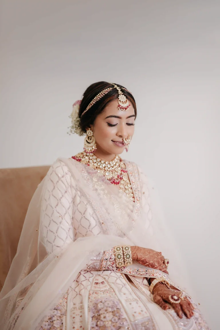 Bride seated in wearing classic white wedding dress