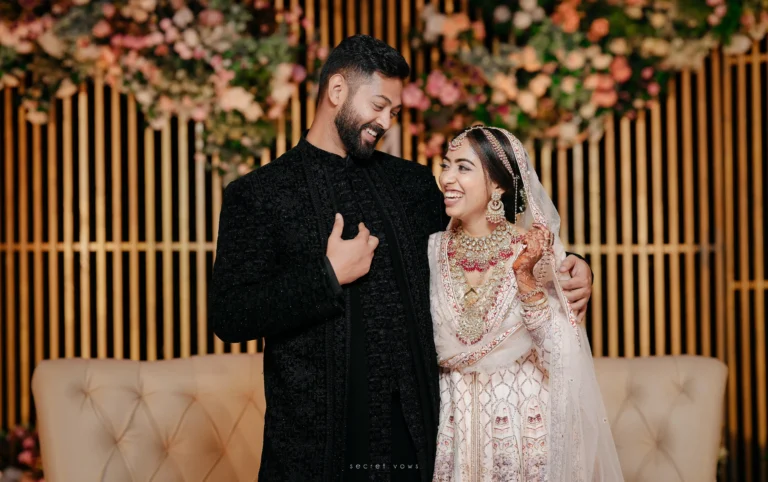 Candid moment of couple laughing on the wedding stage