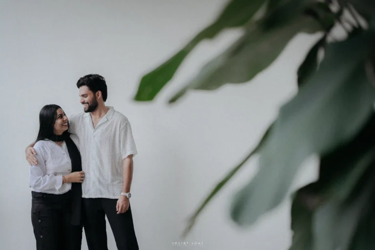 Couple gazing into each other’s eyes with a soft romantic backdrop