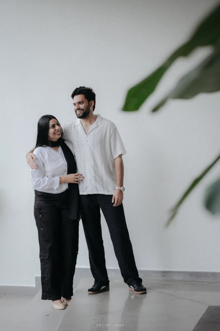 Couple standing close, eyes closed, enjoying a quiet pause