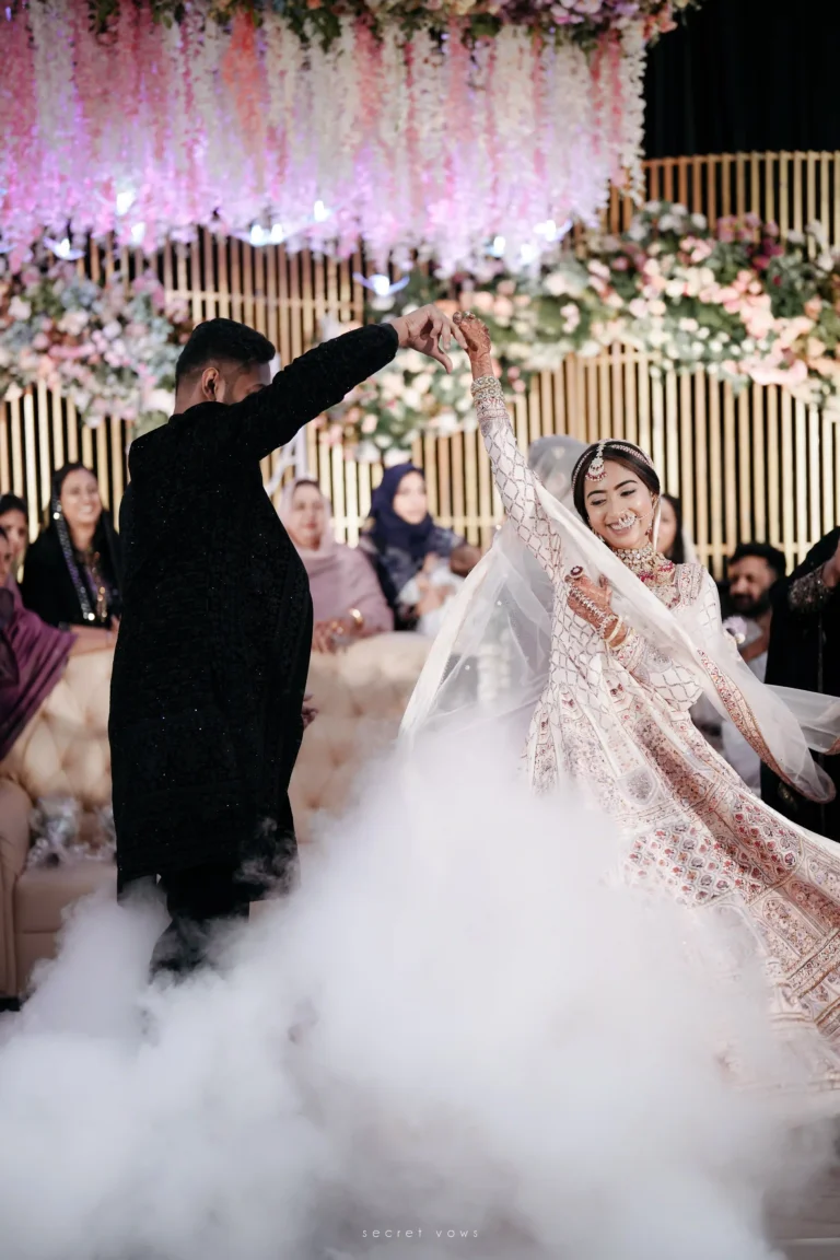 Newlywed couple sharing a joyful moment on stage