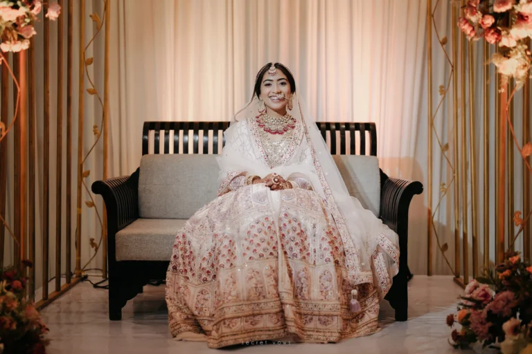 Stunning bride in ivory dress posing in Kerala wedding venue